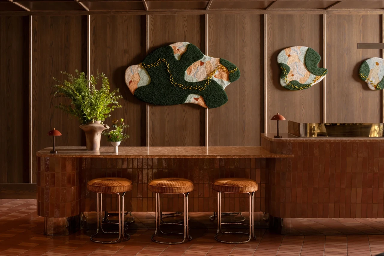 The lobby reception vignette at Hotel Indigo Raleigh Downtown, warm and glowing