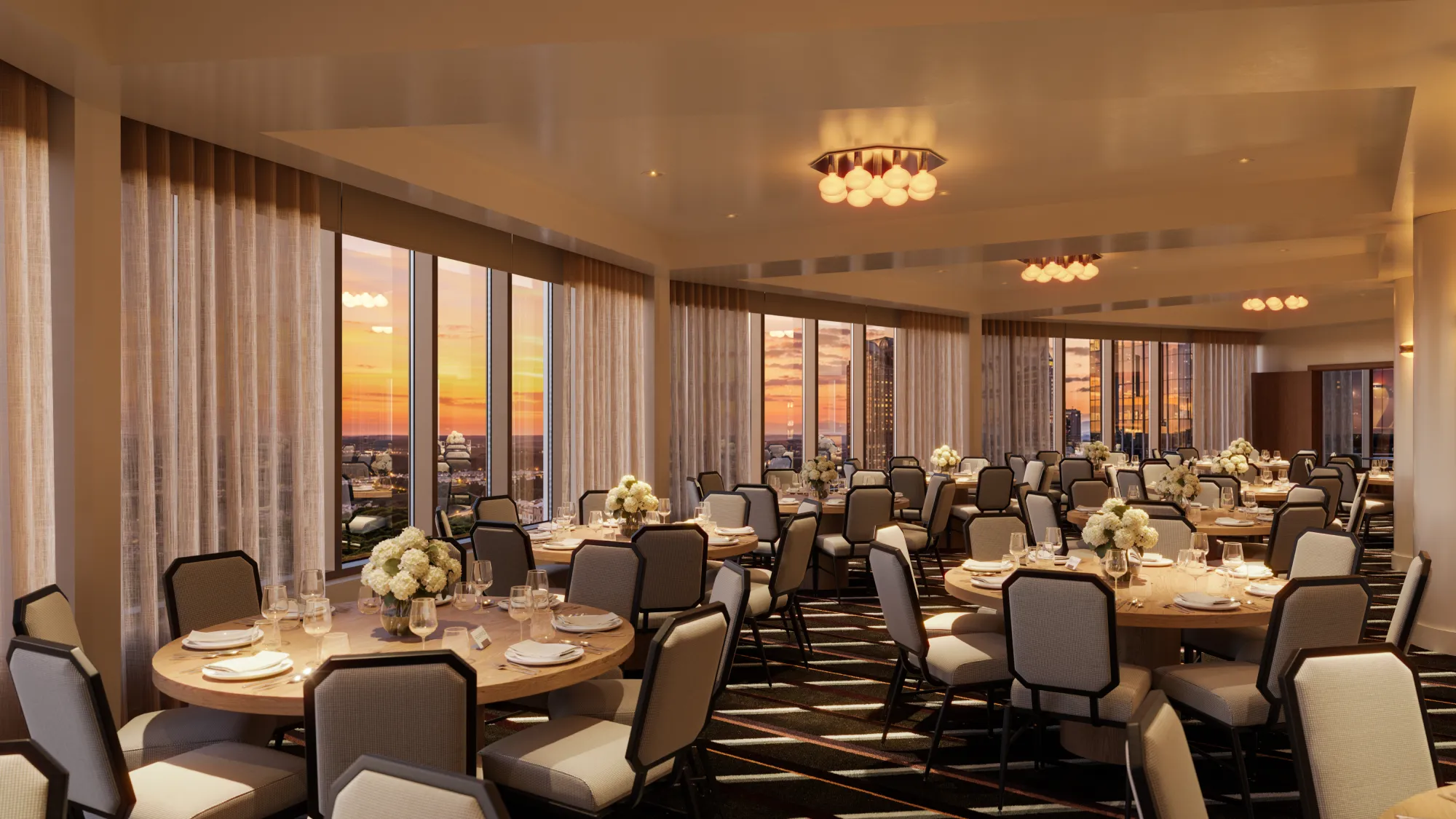 The hotel's dining room glowing warm above downtown Raleigh