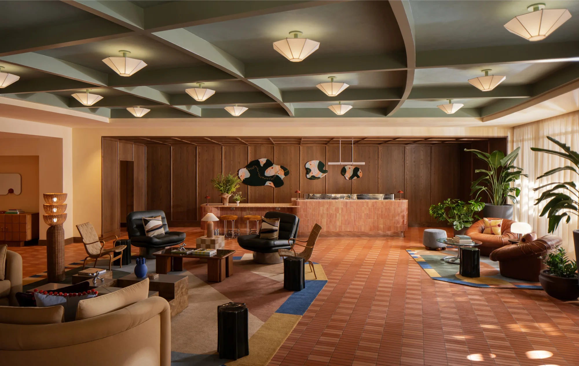 The reimagined lobby of Hotel Indigo Raleigh Downtown with warm mid-century furnishings and curved architecture