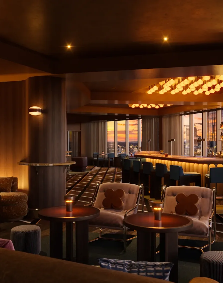 Evening at High Ground Lounge with cocktails against the Raleigh skyline