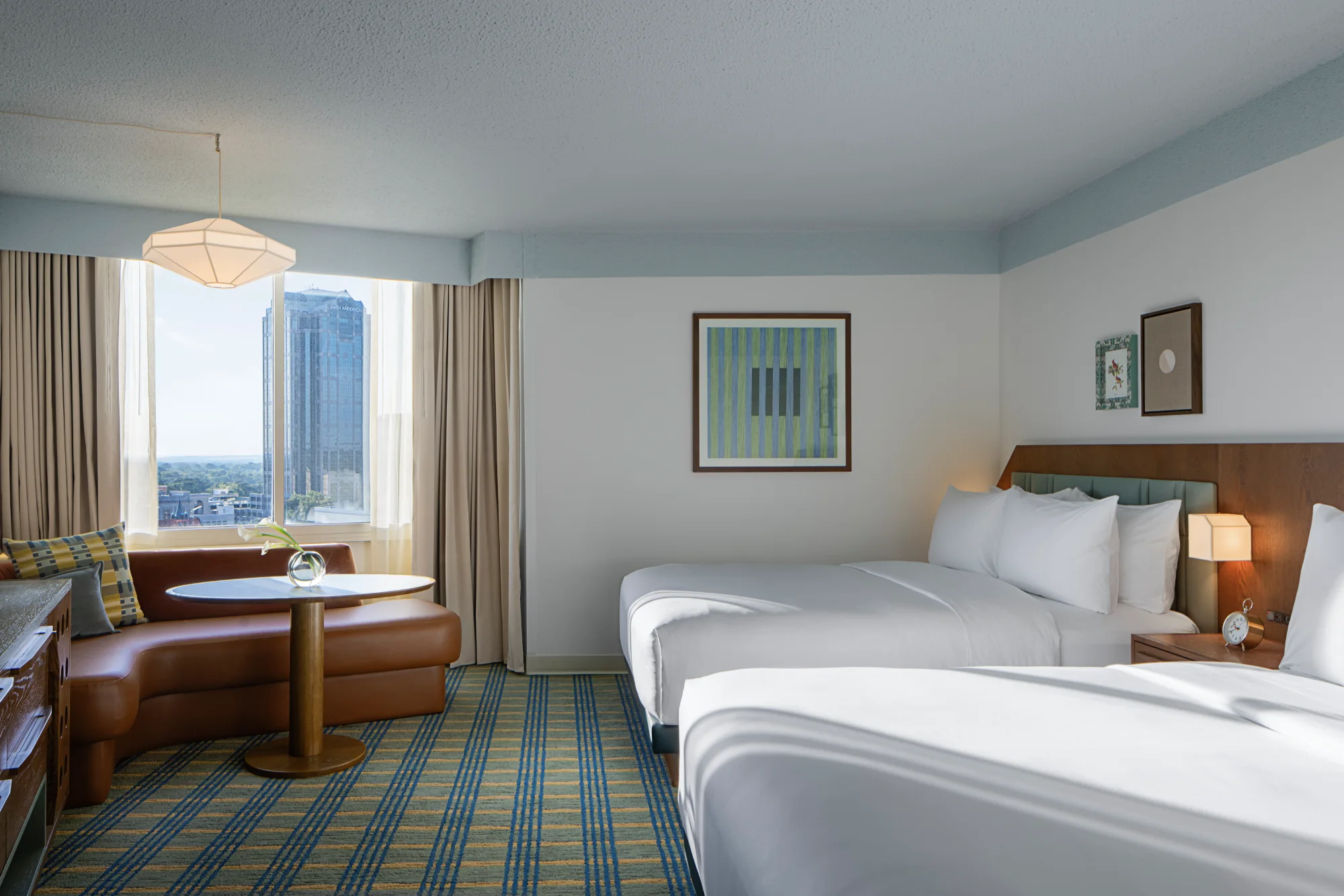 Two Queen Room room with two queen beds and a curved lounge by the window